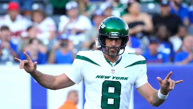 Jets' QB Aaron Rodgers (8) shows love for the crowd